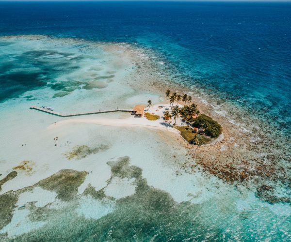 Aerial top view of the Caribbean Sea in the Goff’s Caye island in Belize, Central America An aerial top view of the Caribbean Sea in the Goff's Caye island in Belize, Central America